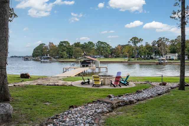 dock area with a water view and a lawn