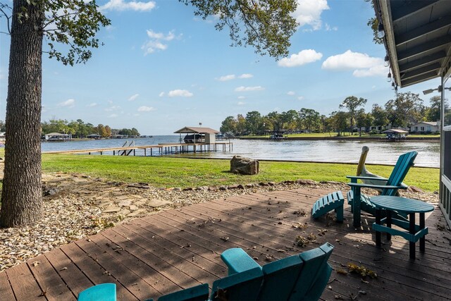 dock area featuring a water view and a yard