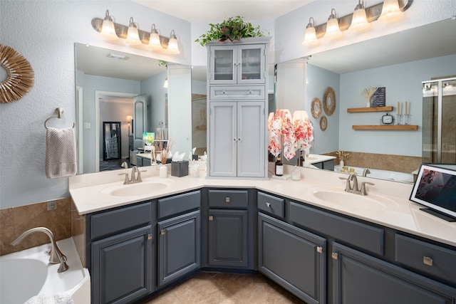 bathroom featuring tile patterned floors, vanity, and a tub