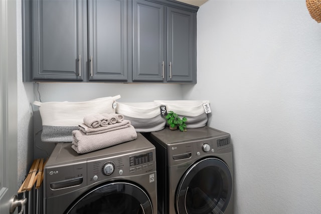 laundry room featuring cabinets and separate washer and dryer