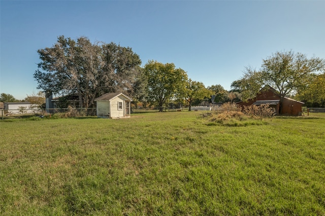 view of yard featuring a rural view and a storage unit