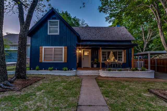 view of front of property featuring a lawn and a porch