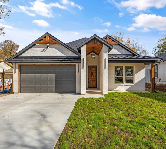 view of front of home featuring a garage and a front lawn