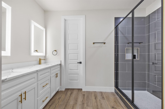 bathroom with vanity, an enclosed shower, and hardwood / wood-style flooring