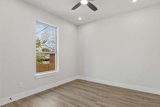 spare room featuring light wood-type flooring and ceiling fan