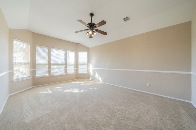 carpeted empty room featuring ceiling fan and lofted ceiling