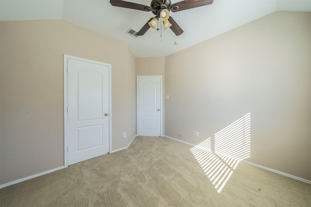 unfurnished bedroom with ceiling fan, light carpet, and lofted ceiling