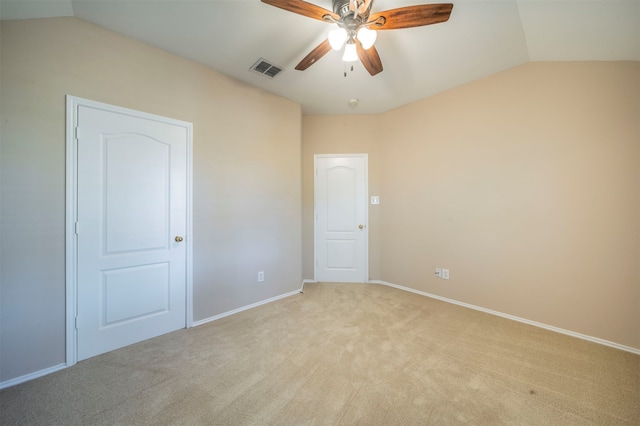 carpeted empty room featuring ceiling fan and vaulted ceiling