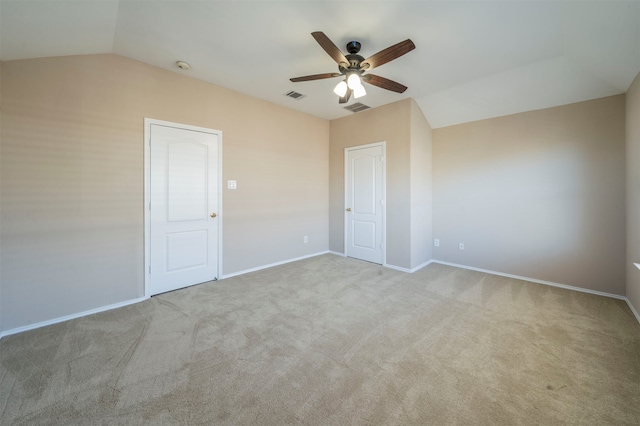 spare room featuring light carpet, ceiling fan, and lofted ceiling