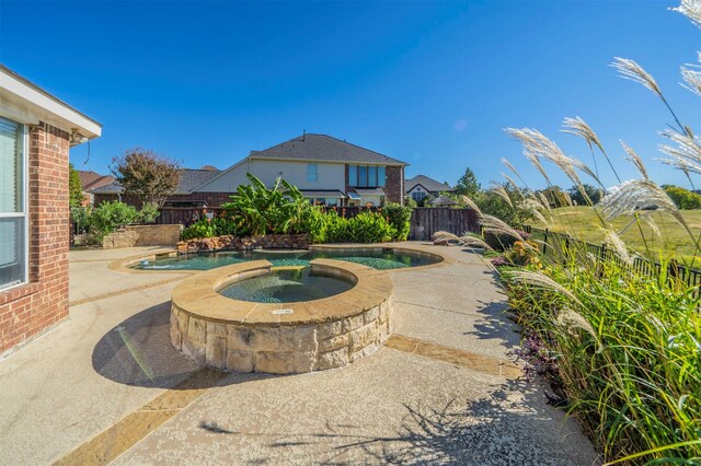 view of pool with an in ground hot tub