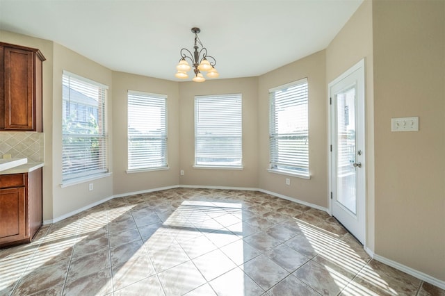 unfurnished dining area featuring a notable chandelier and light tile patterned floors