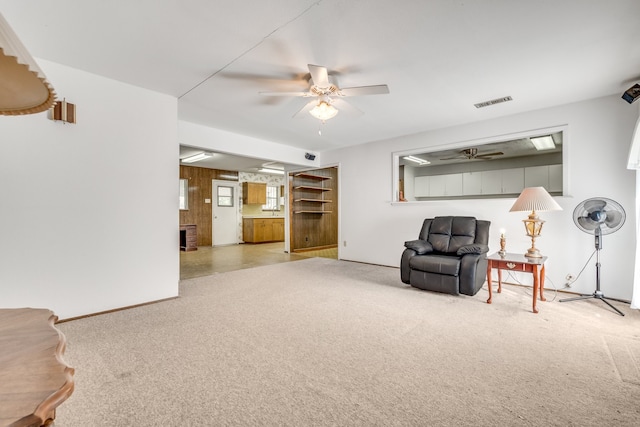 sitting room with light carpet and ceiling fan