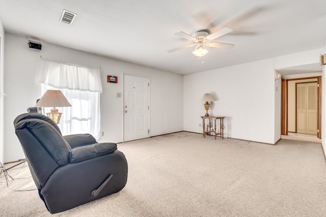 sitting room featuring ceiling fan and light colored carpet