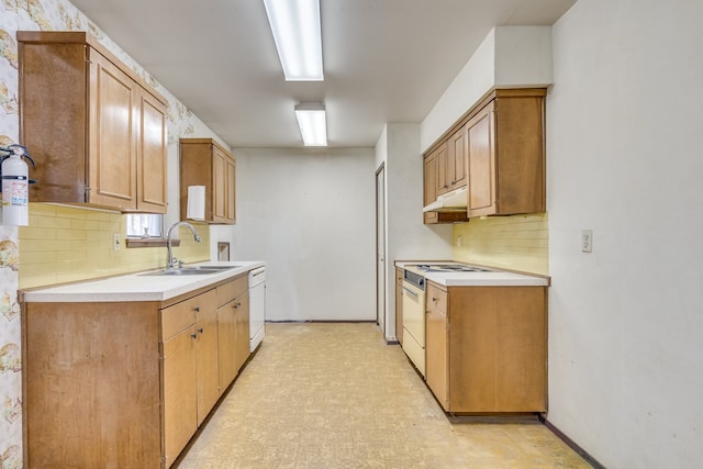 kitchen with white appliances, backsplash, and sink