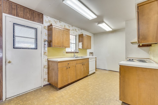 kitchen featuring white dishwasher, tasteful backsplash, and sink