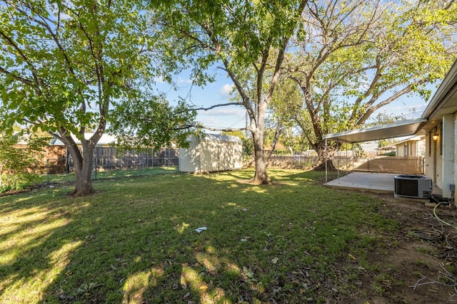 view of yard featuring a shed, central AC unit, and a patio area