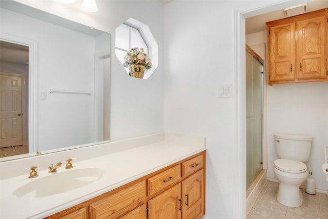 bathroom featuring tile patterned flooring, vanity, an enclosed shower, and toilet