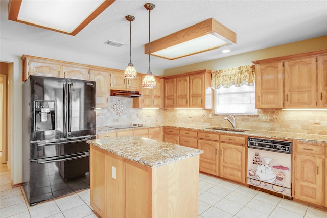 kitchen featuring light stone countertops, sink, decorative light fixtures, a kitchen island, and black appliances