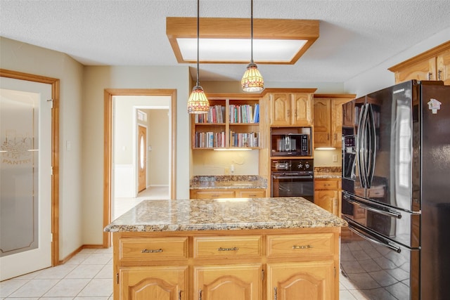 kitchen featuring hanging light fixtures, a center island, black appliances, and a textured ceiling