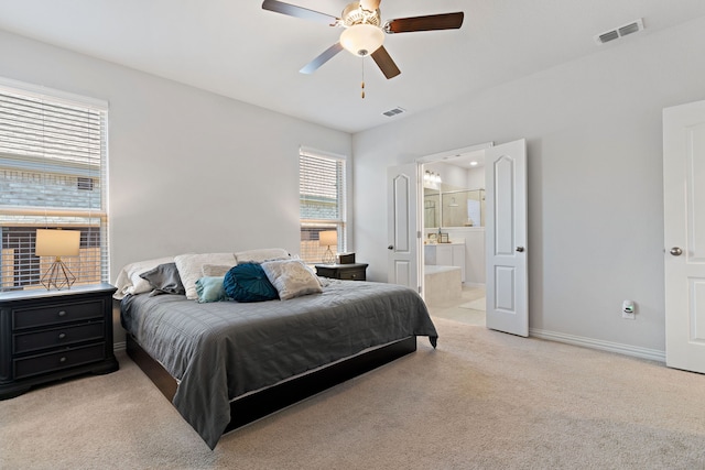 carpeted bedroom with ceiling fan and connected bathroom