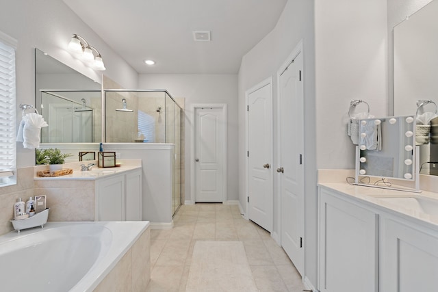 bathroom featuring tile patterned flooring, vanity, and separate shower and tub