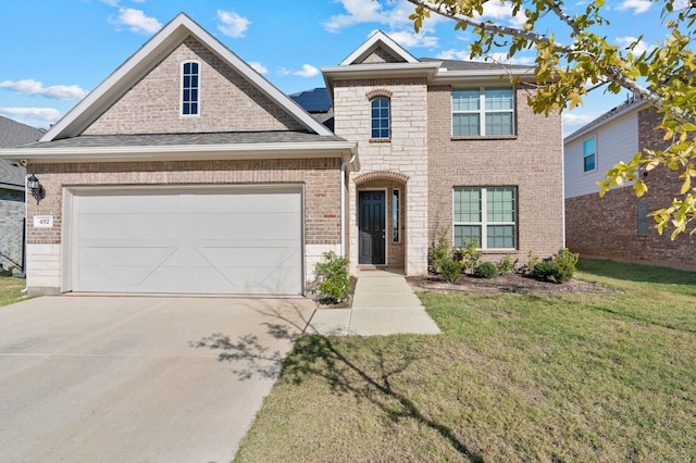 view of front of home with a garage and a front lawn