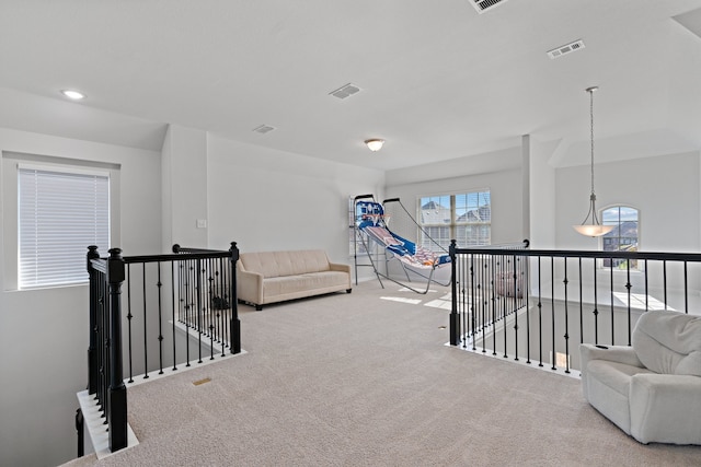 sitting room featuring light colored carpet