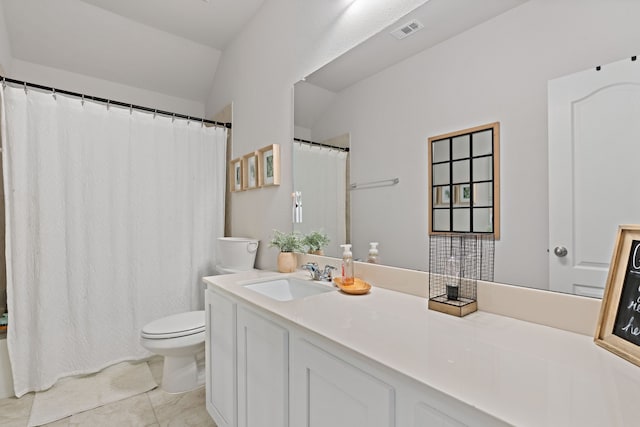 bathroom featuring tile patterned floors, vanity, toilet, and vaulted ceiling