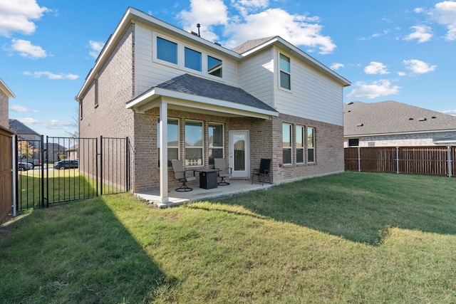 back of property featuring a patio area and a yard