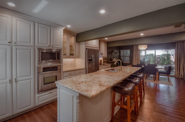 743 Oakwood Trl, Fort Worth, TX 76112 - kitchen featuring a sink, appliances with stainless steel finishes, light stone counters, and dark wood-type flooring