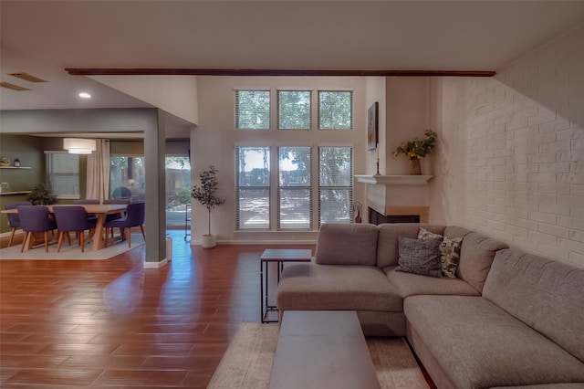 743 Oakwood Trl, Fort Worth, TX 76112 - living room with baseboards, visible vents, wood finished floors, and brick wall
