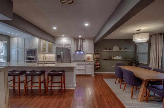 kitchen featuring pendant lighting, stainless steel appliances, white cabinetry, and sink