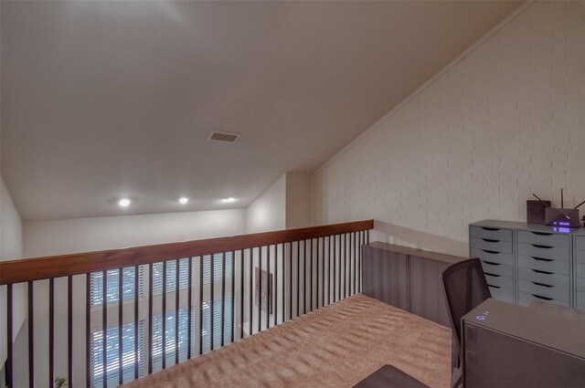 743 Oakwood Trl, Fort Worth, TX 76112 - corridor featuring lofted ceiling, visible vents, and brick wall