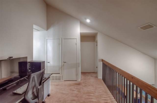 office space featuring light carpet and vaulted ceiling