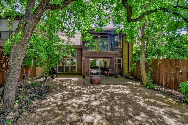 back of property featuring a patio and a balcony