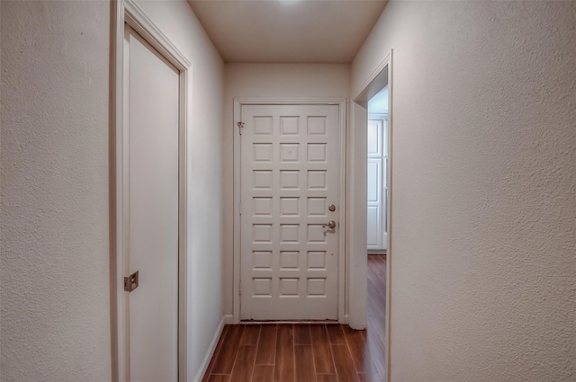 corridor featuring wood-type flooring