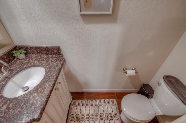 743 Oakwood Trl, Fort Worth, TX 76112 - bathroom with baseboards, toilet, and vanity