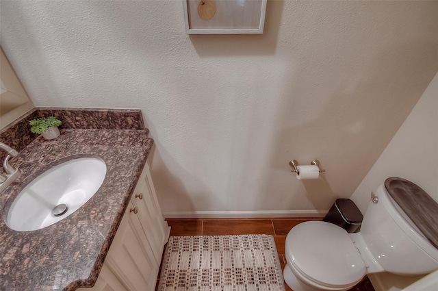 bathroom featuring tile patterned flooring, vanity, and toilet