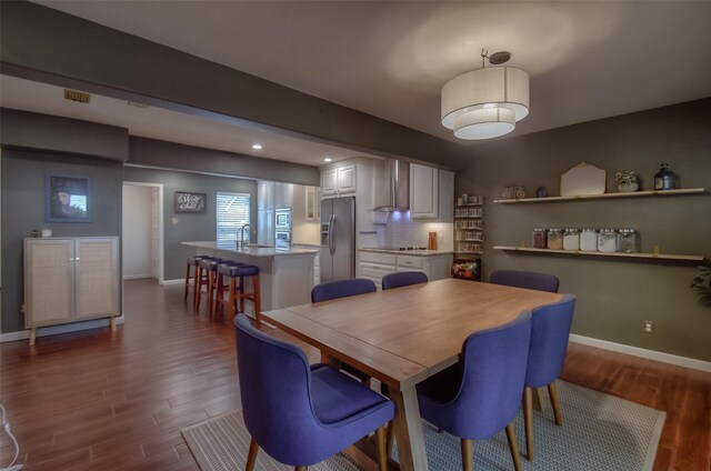 dining room featuring dark wood-type flooring and sink