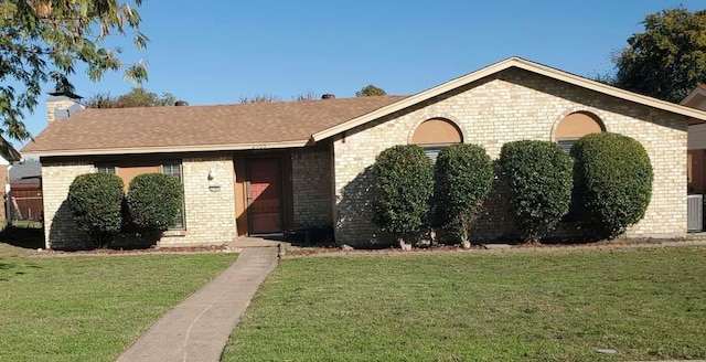 single story home featuring a front lawn and cooling unit