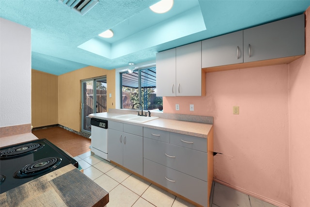 kitchen featuring gray cabinetry, sink, white dishwasher, a textured ceiling, and light tile patterned floors