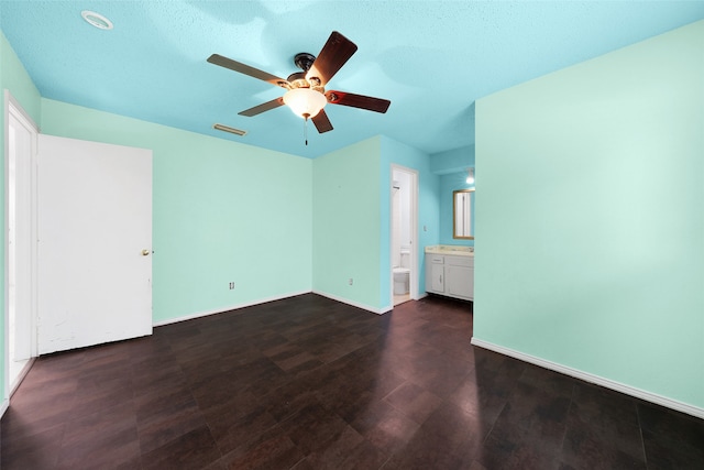 interior space featuring a textured ceiling, dark hardwood / wood-style flooring, and ceiling fan