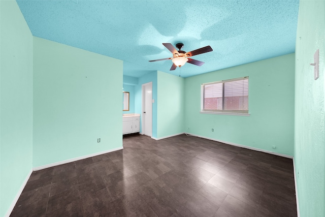 spare room featuring a textured ceiling and ceiling fan