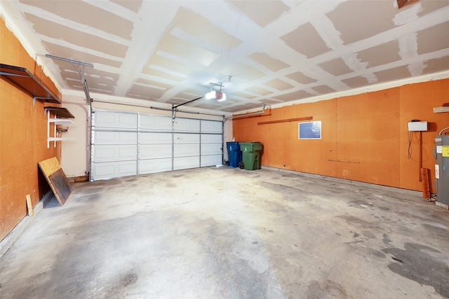 garage featuring water heater and a garage door opener