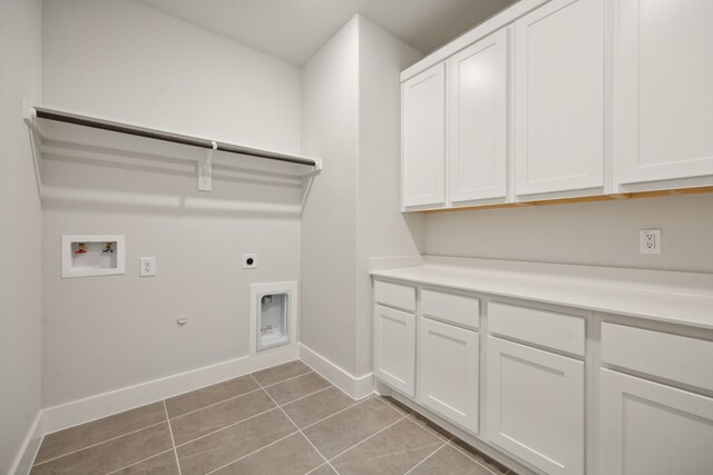 washroom featuring cabinets, hookup for a washing machine, hookup for an electric dryer, hookup for a gas dryer, and light tile patterned flooring