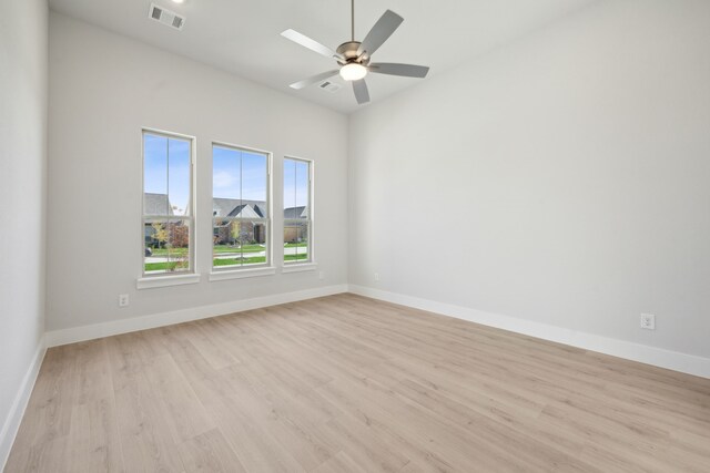 empty room with light hardwood / wood-style flooring and ceiling fan