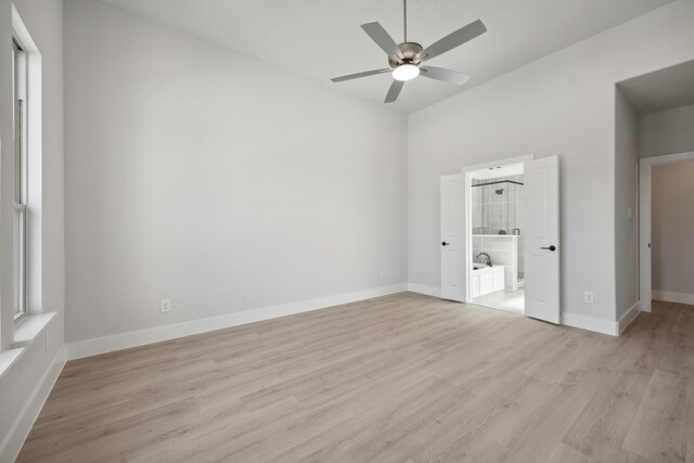 unfurnished bedroom with ensuite bathroom, ceiling fan, and light hardwood / wood-style floors