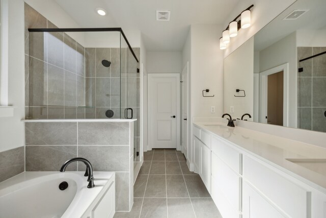 bathroom with tile patterned floors, vanity, and independent shower and bath