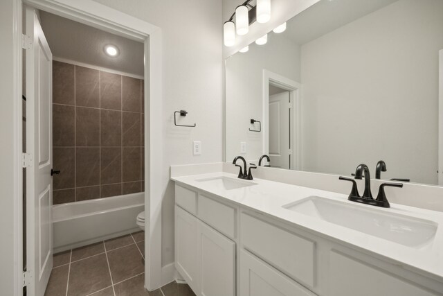 full bathroom with tile patterned flooring, vanity, toilet, and tiled shower / bath