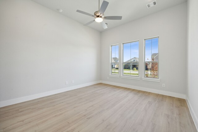 empty room featuring ceiling fan and light wood-type flooring